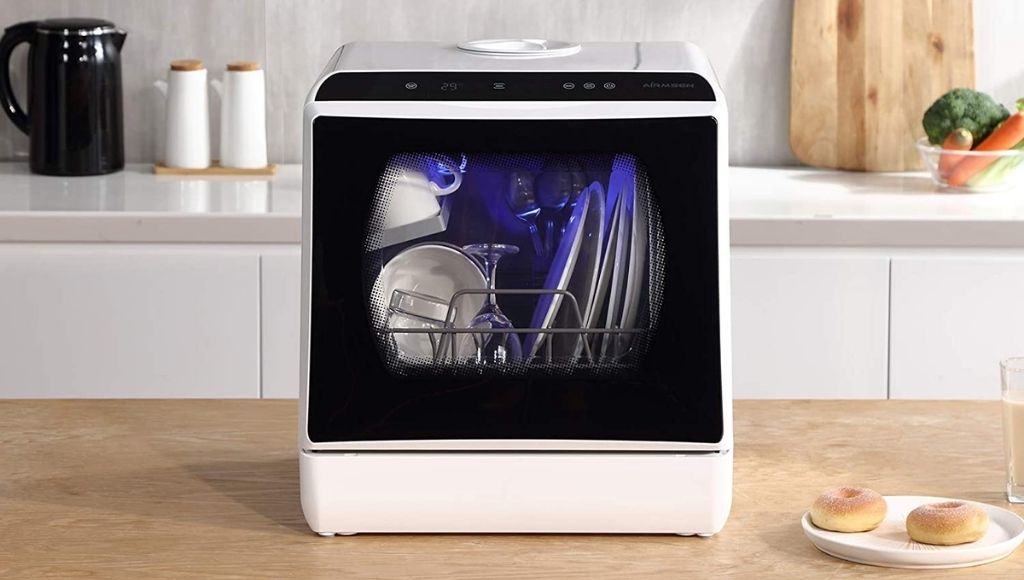 A mini portable countertop dishwasher in the kitchen