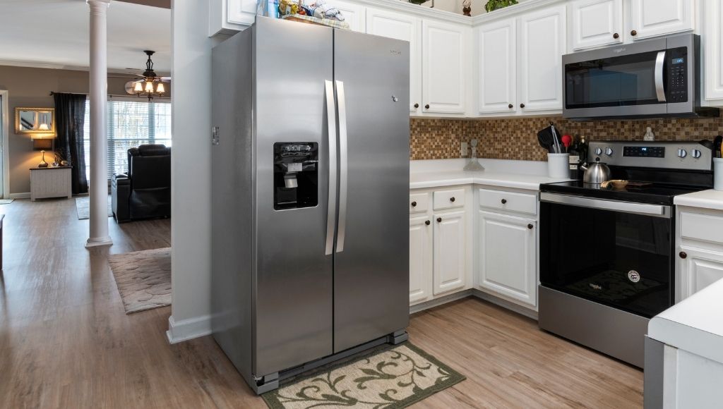 A stainless steel color side by side fridge in the kitchen