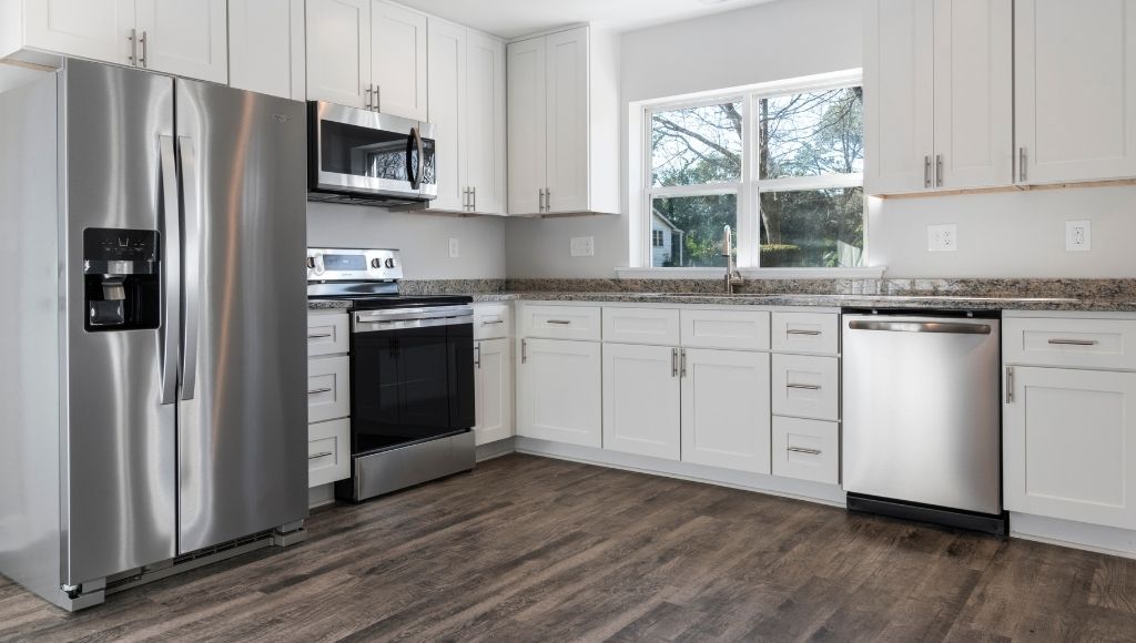 A big silver color smart refrigerator in the kitchen on the left side